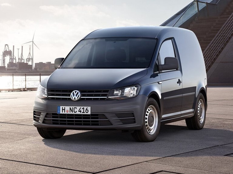 Small, black Volkswagen rental vehicle parked at the side of a dock, with a staircase behind.